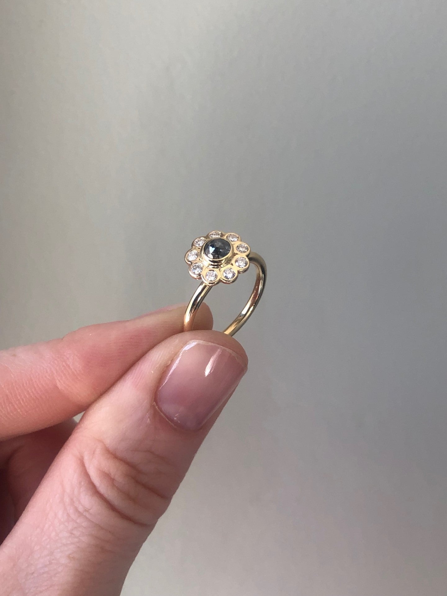 Daisy diamond ring with salt and pepper diamond with hand