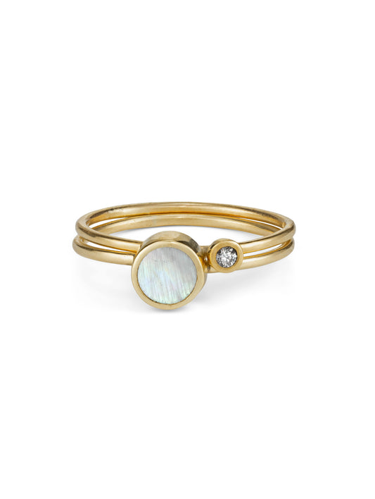 A Mother of Pearl stacking ring paired with a tiny delicate diamond stacking ring in yellow gold.