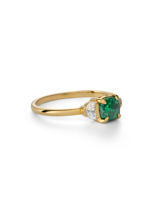 Cushion cut emerald trilogy ring.