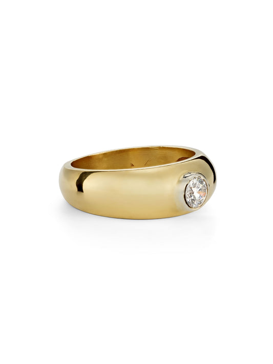 A polished yellow gold ring with a single round 0.5ct diamond set in a bezel setting on the right side, shown against a plain white background.
