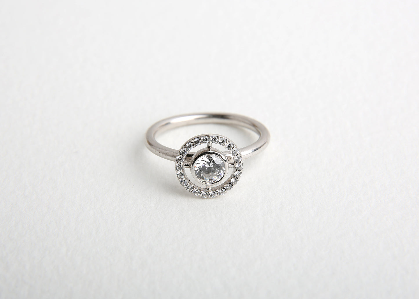 celestial white gold and diamond engagement ring on white table 