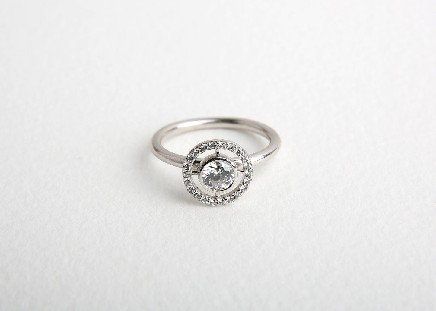 celestial white gold and diamond engagement ring on white table