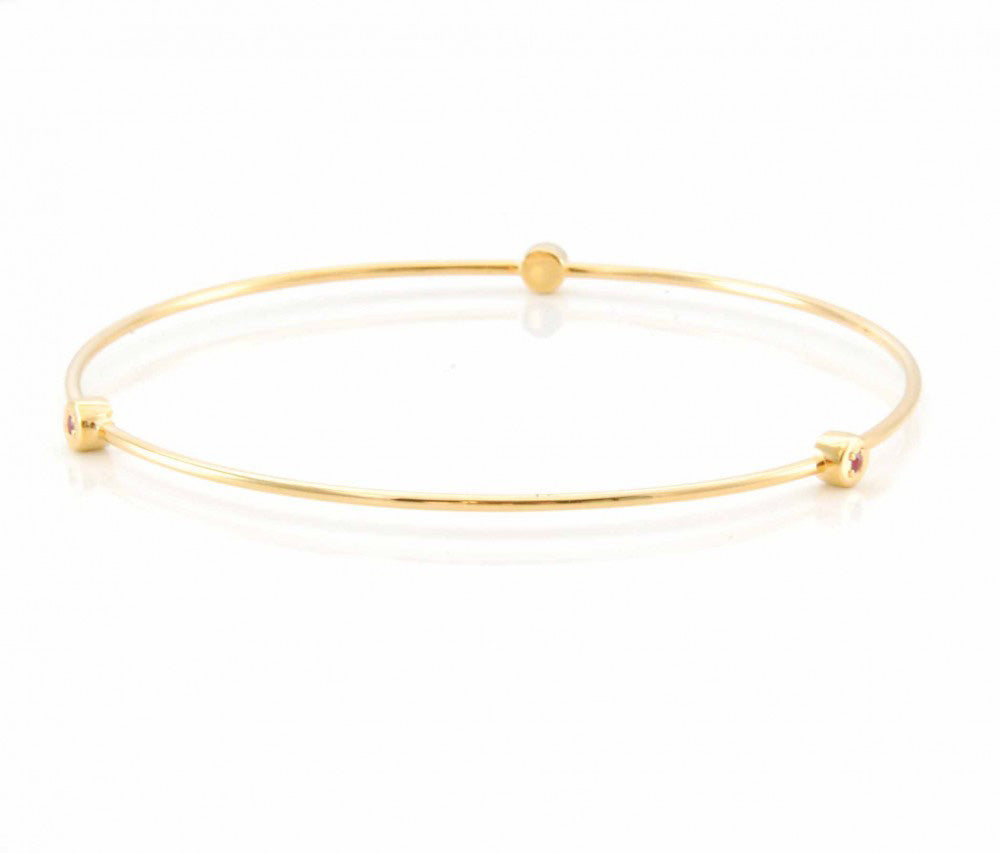 gold gemstone stud bangle on white table