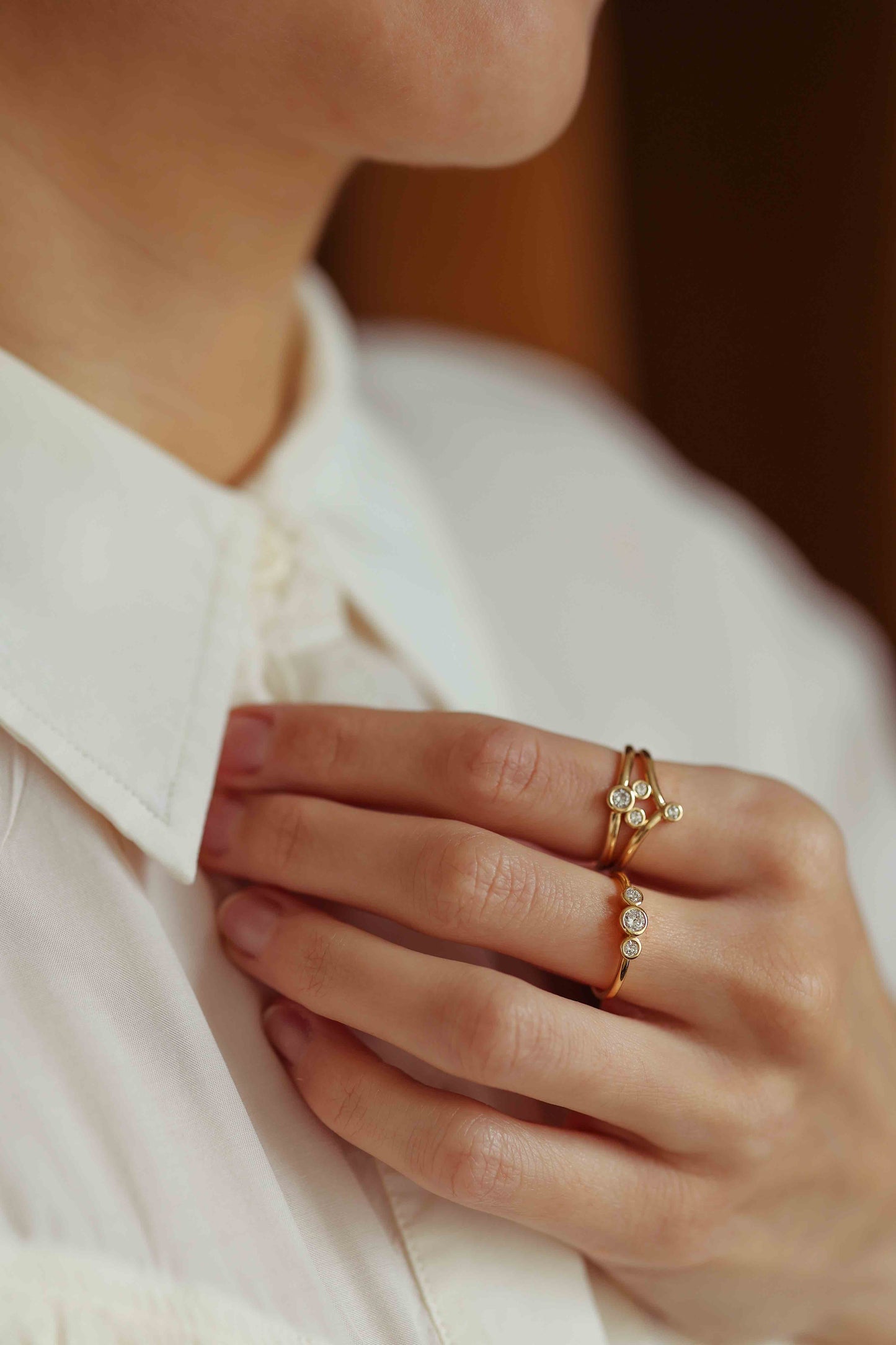 multi stone gold and diamond ring on model