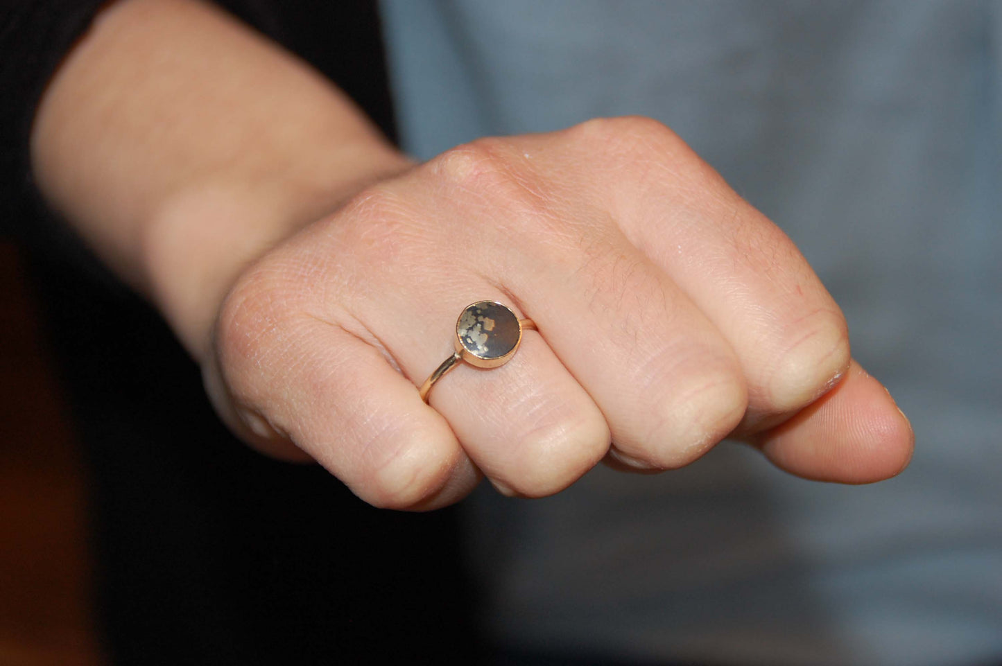 stellar black and gold ring on hand