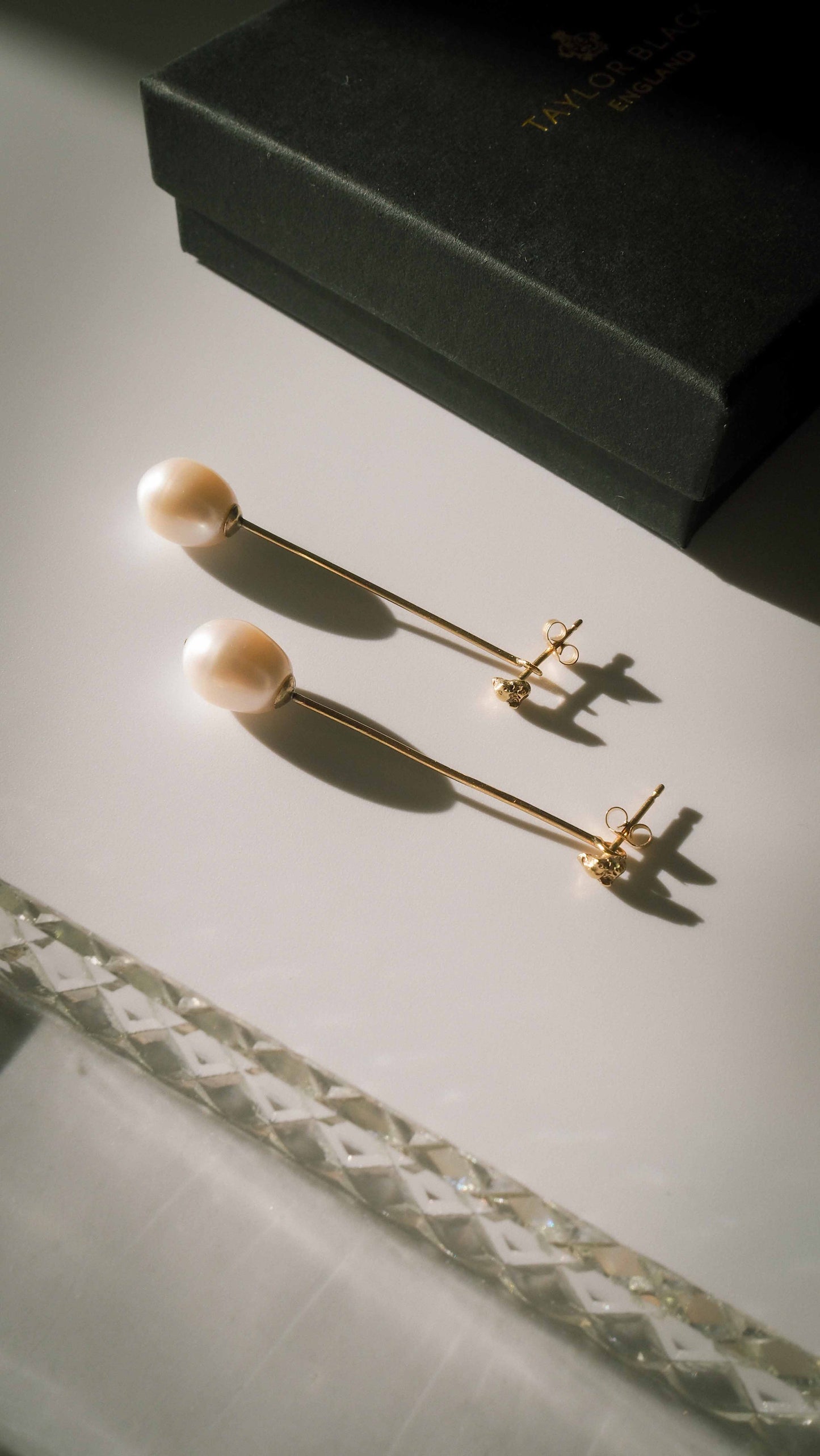 handmade drop pearl stem and gold bridal earrings on table with box