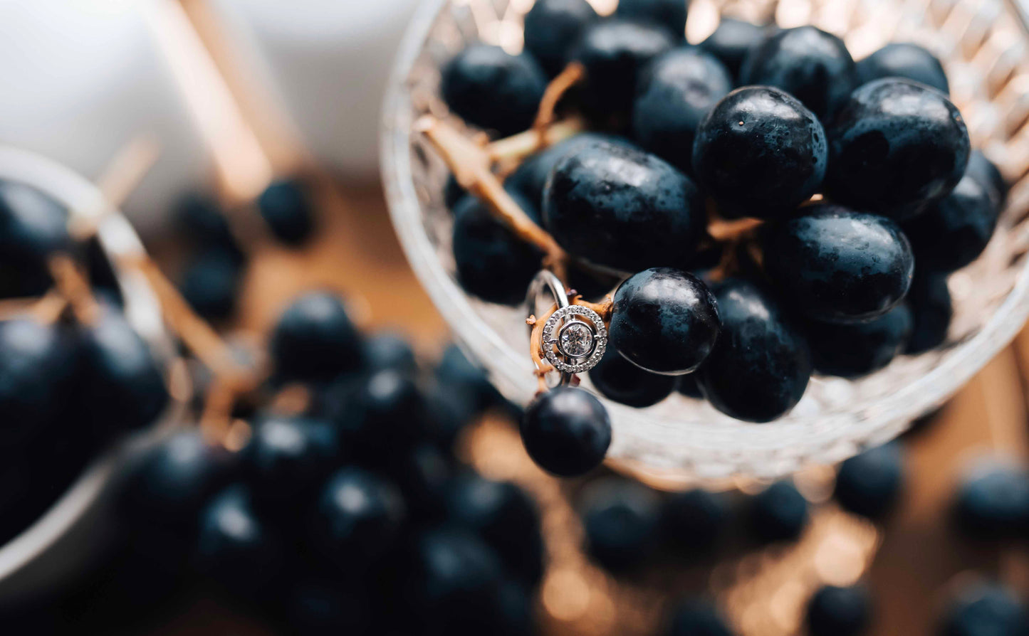 celestial white gold and diamond engagement ring on grapes