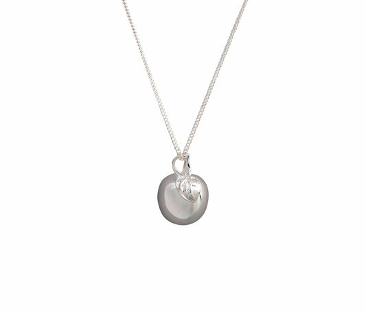 silver apple necklace on white background