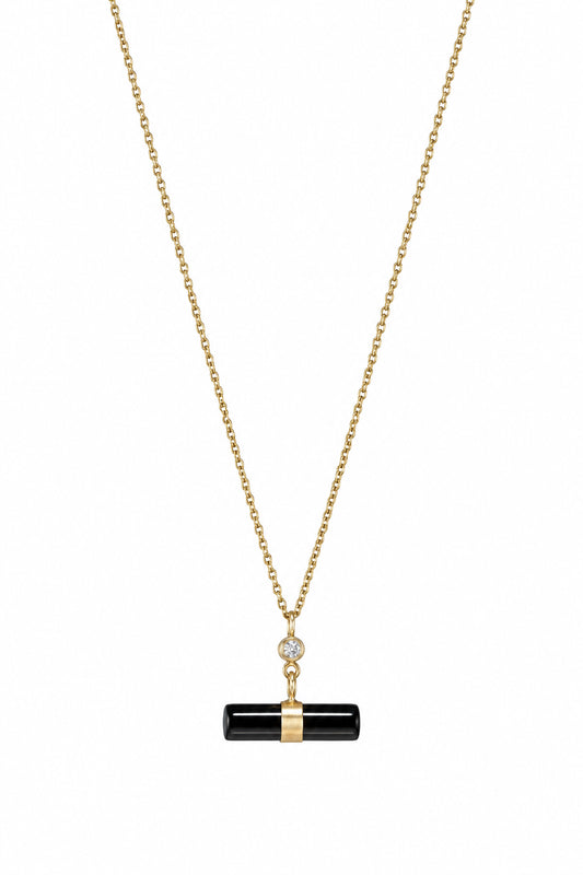 A yellow gold chain necklace featuring T bar style pendant.  A cylinder of black onyx with a white diamond.