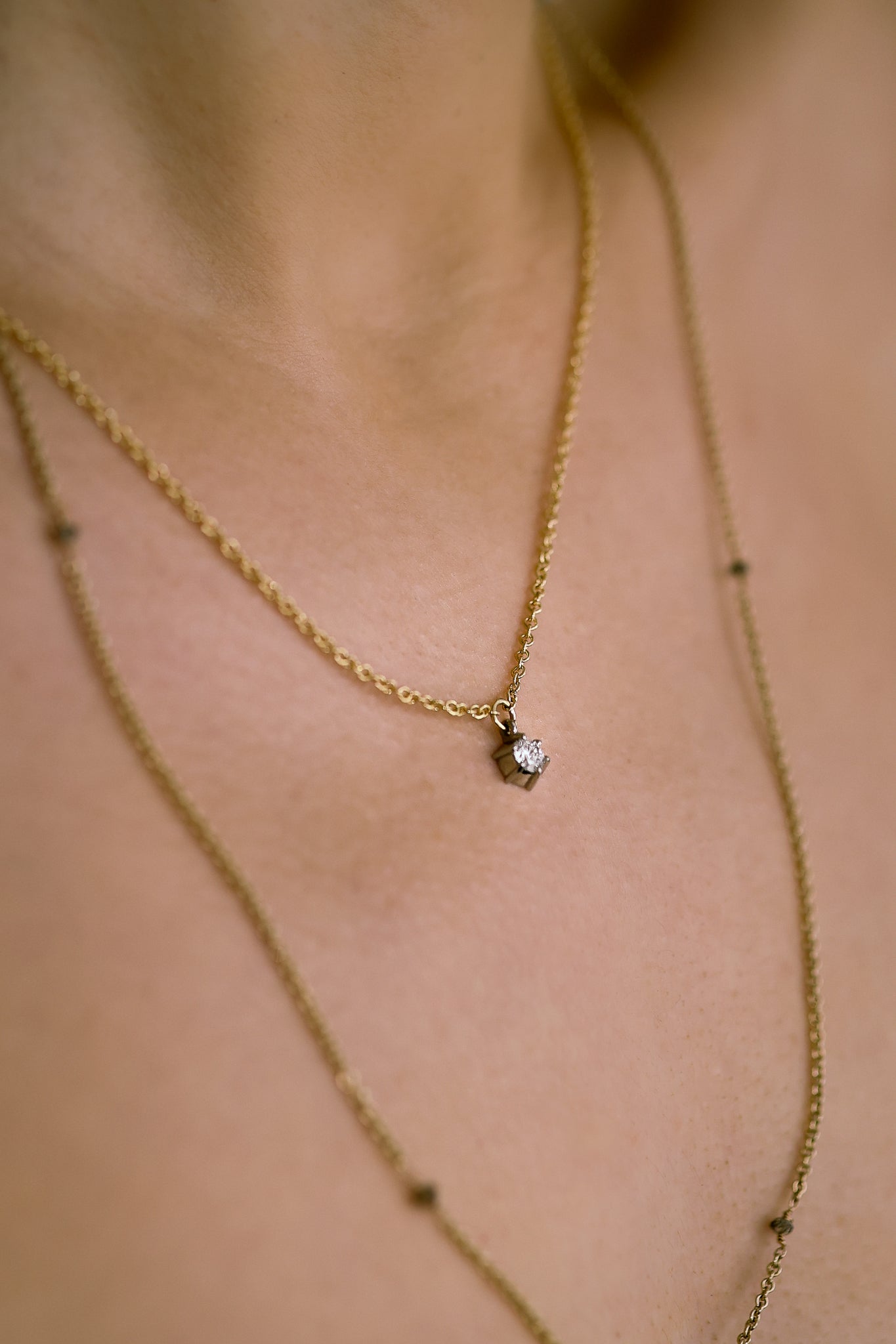 diamond star dropper gold necklace on model
