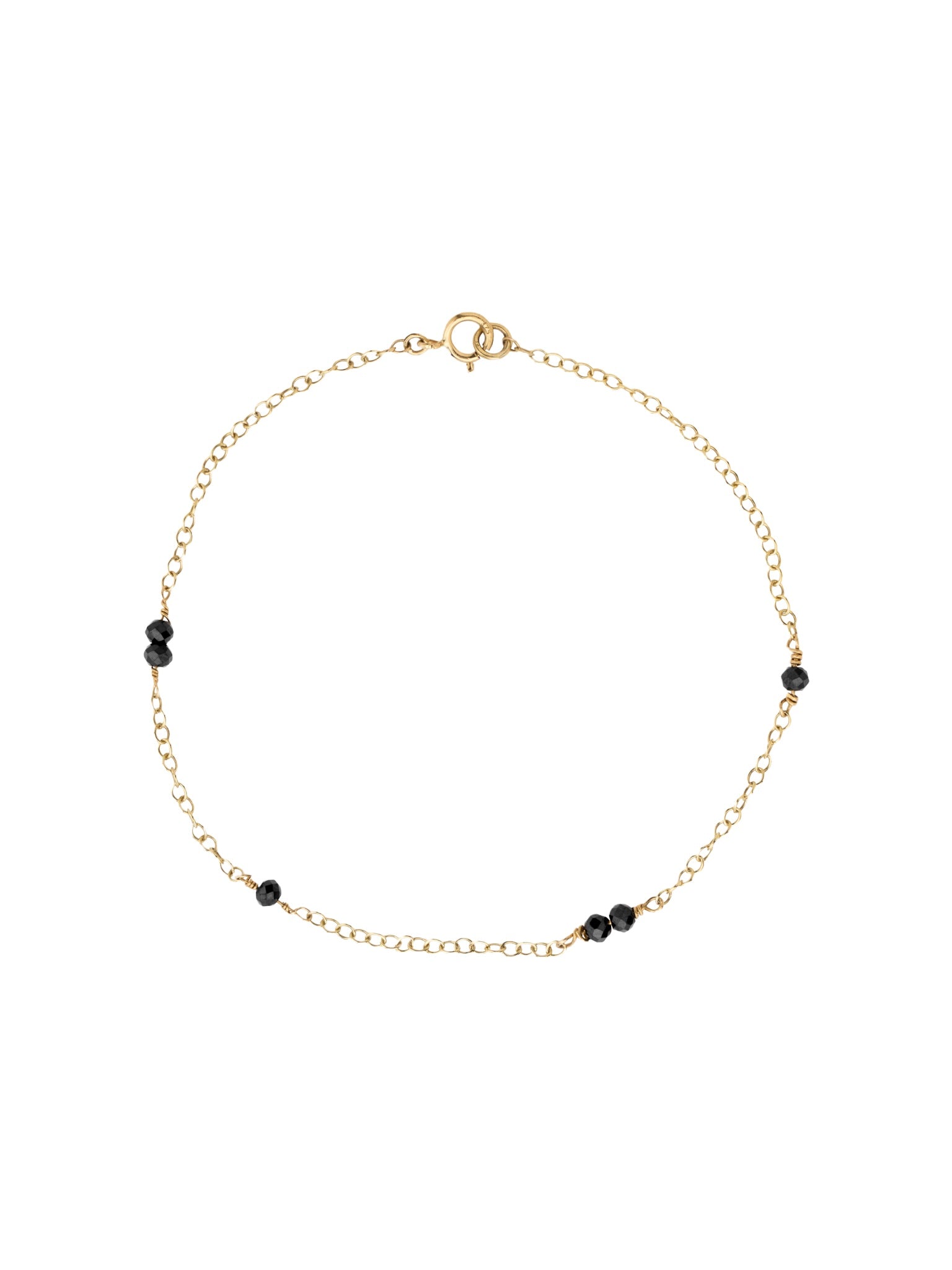 Gold bracelet with black spinel beads on a white background