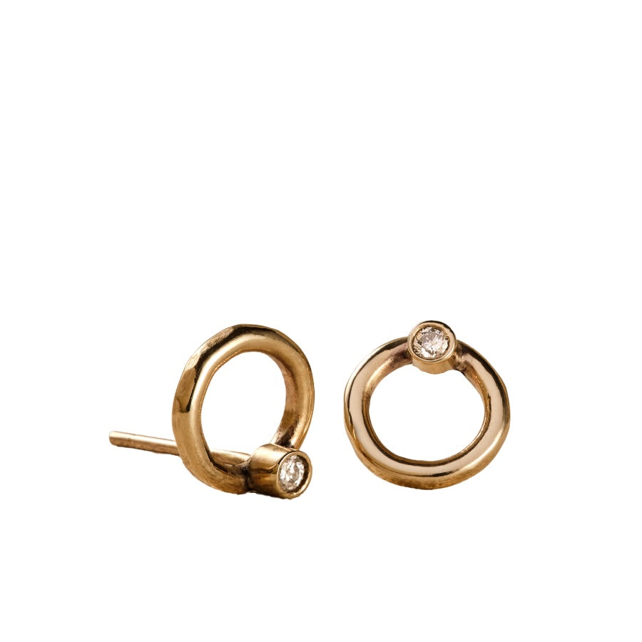 Gold circle earrings with tiny diamonds.