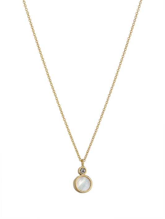 A delicate gold chain necklace featuring a round white mother-of-pearl pendant with a small diamond accent above it, set against a solid white background.