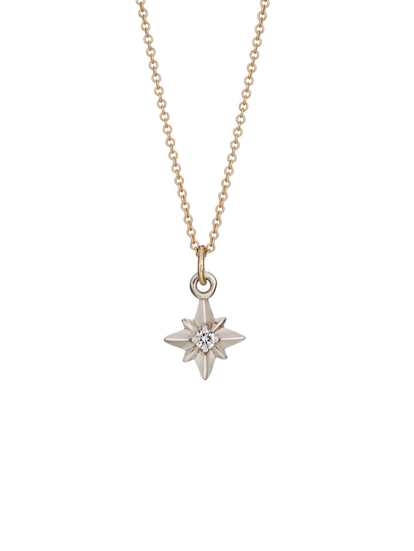 A silver pointed star necklace pendant with a central diamond, attached to a yellow gold chain.