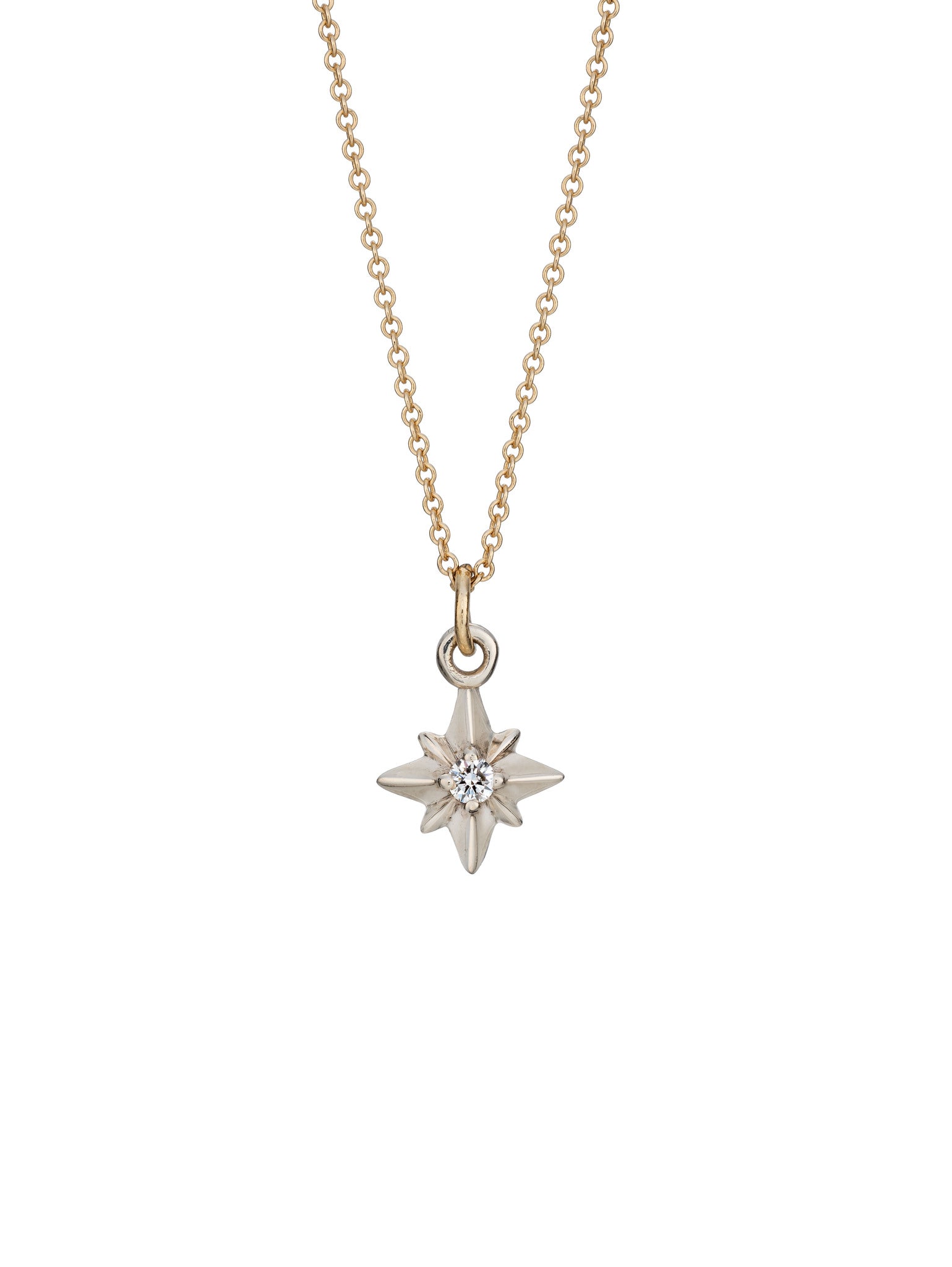 A silver pointed star necklace pendant with a central diamond, attached to a yellow gold chain.