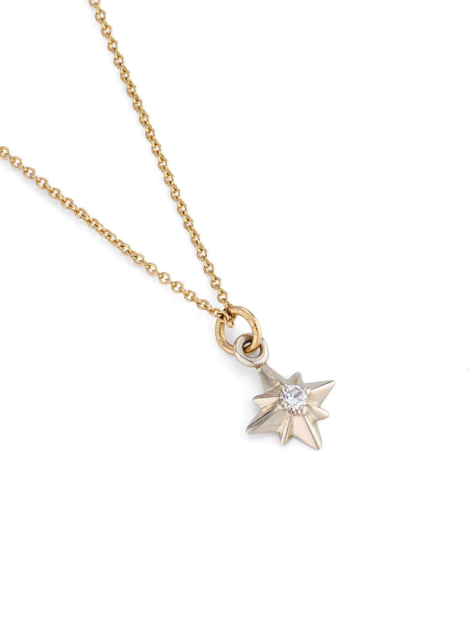 Silver pointed star necklace with central diamond on yellow gold chain