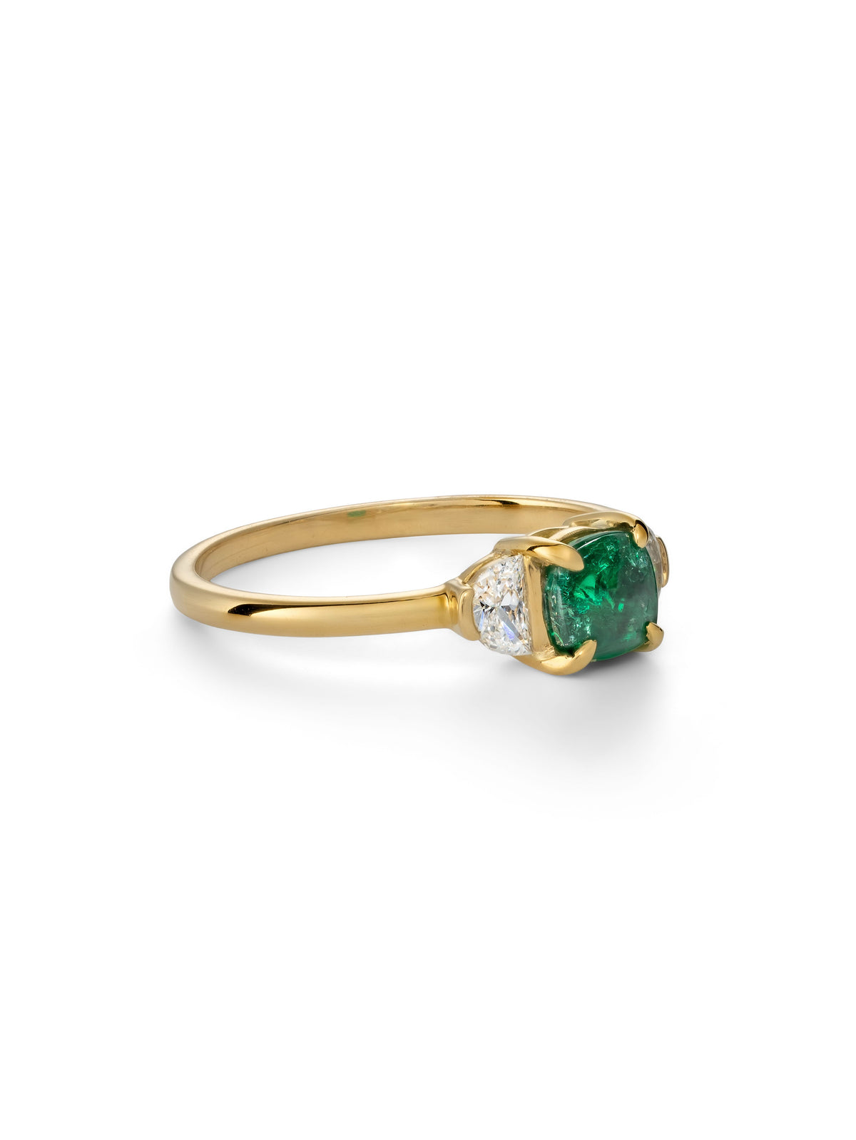 Cushion cut emerald trilogy ring.