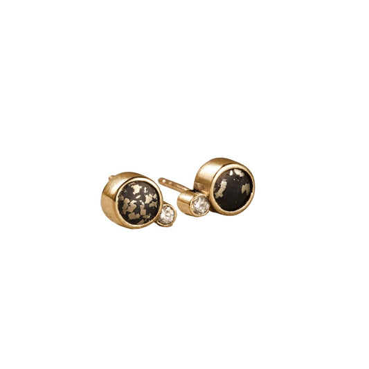 Gold earrings with black stones on a white background