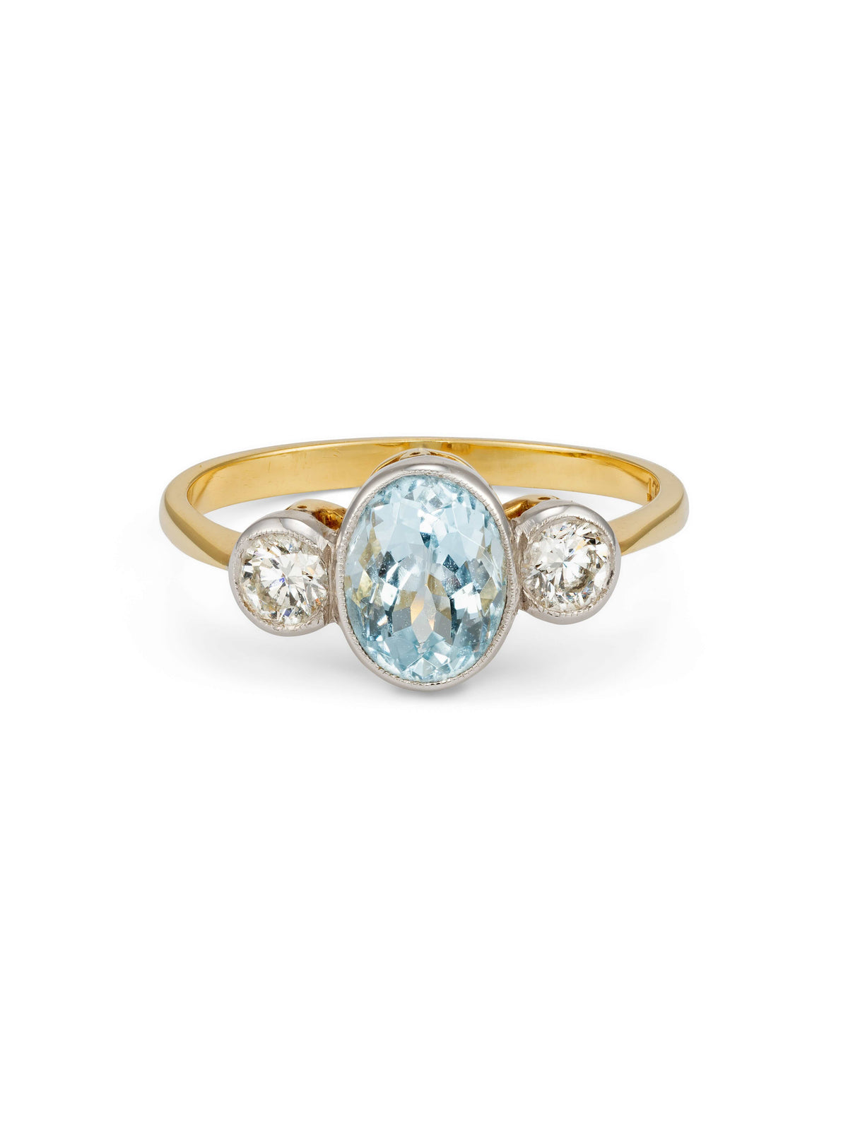 A vintage yellow gold ring featuring an oval-cut Aquamarine center stone and two round-cut diamonds.