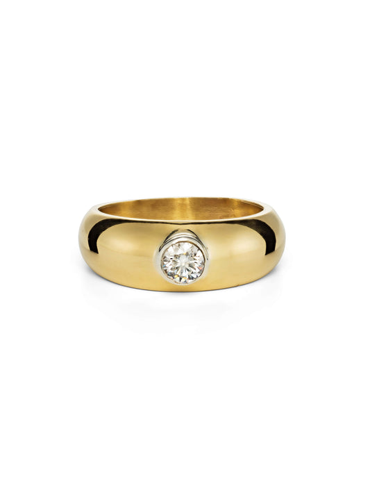 A polished chunky yellow gold bombe ring featuring a single round-cut diamond in a bezel setting, photographed on a seamless white background.