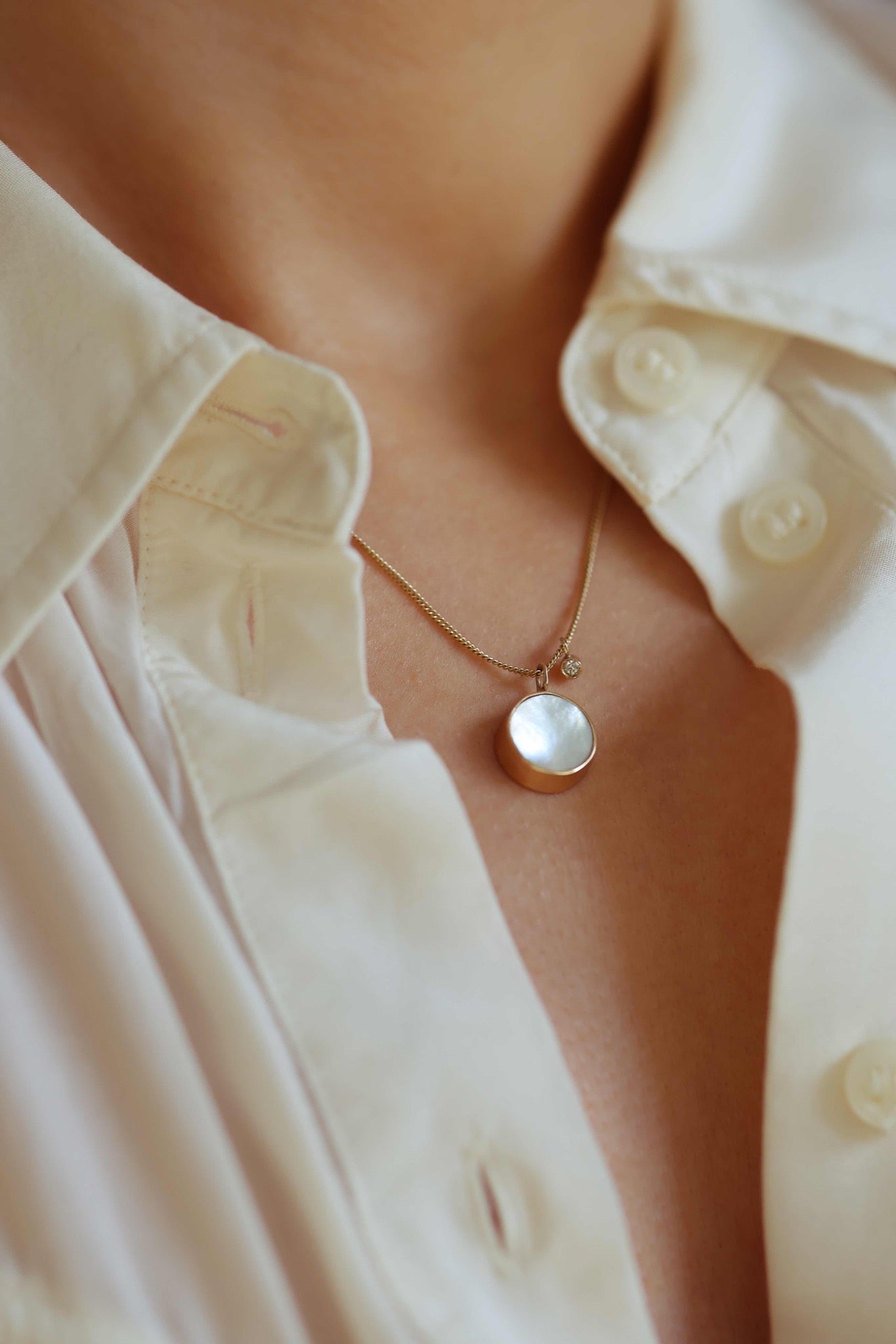 small mother of pearl pendant necklace on model with diamond