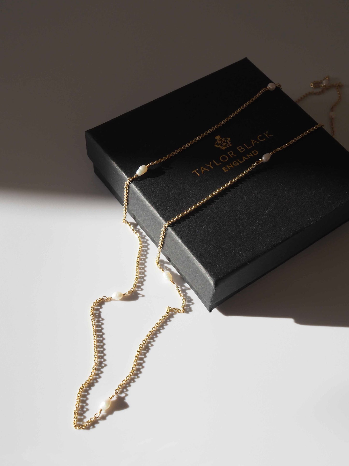 rice pearl and gold necklace on box