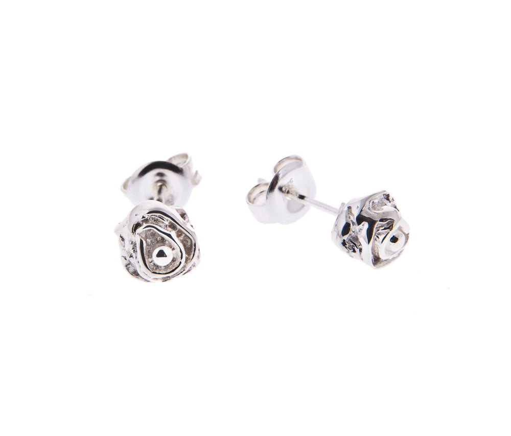 delicate silver rose stud earrings on white background