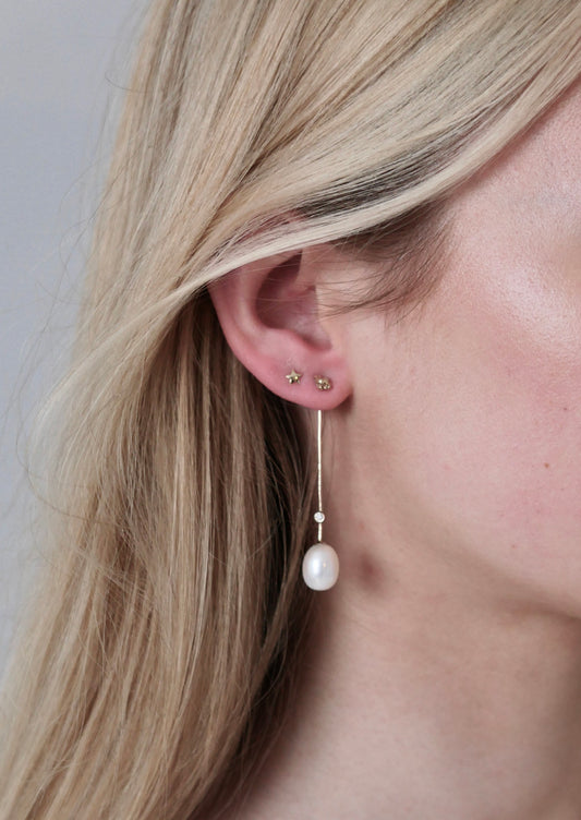 drop stem gold earrings with pearl and diamonds on model