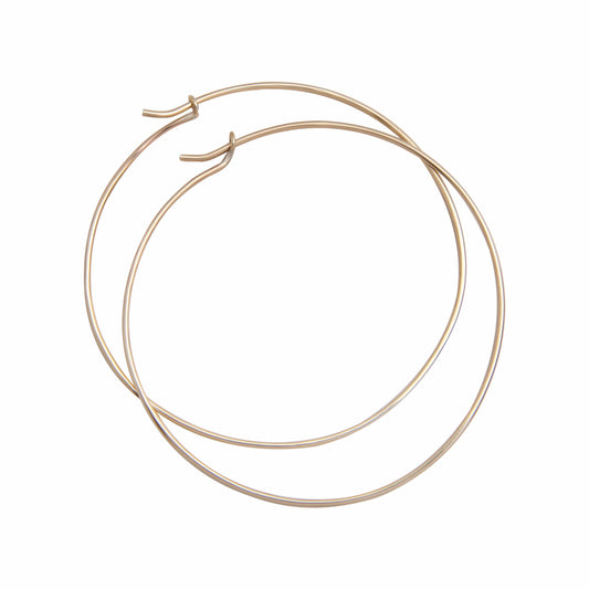 large solid gold hoop earrings white background