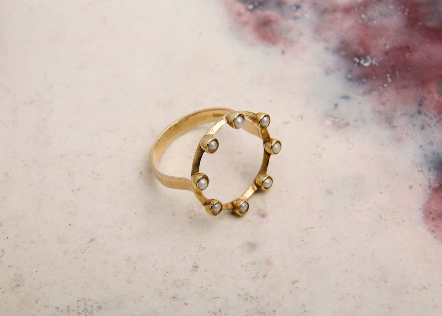 handmade pearl and gold circle ring pink marbled background
