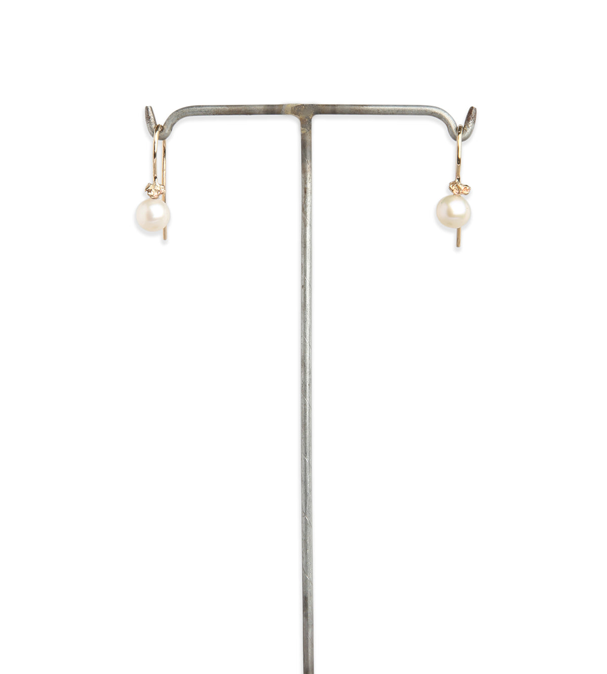 pearl and gold nugget hook earrings on stand