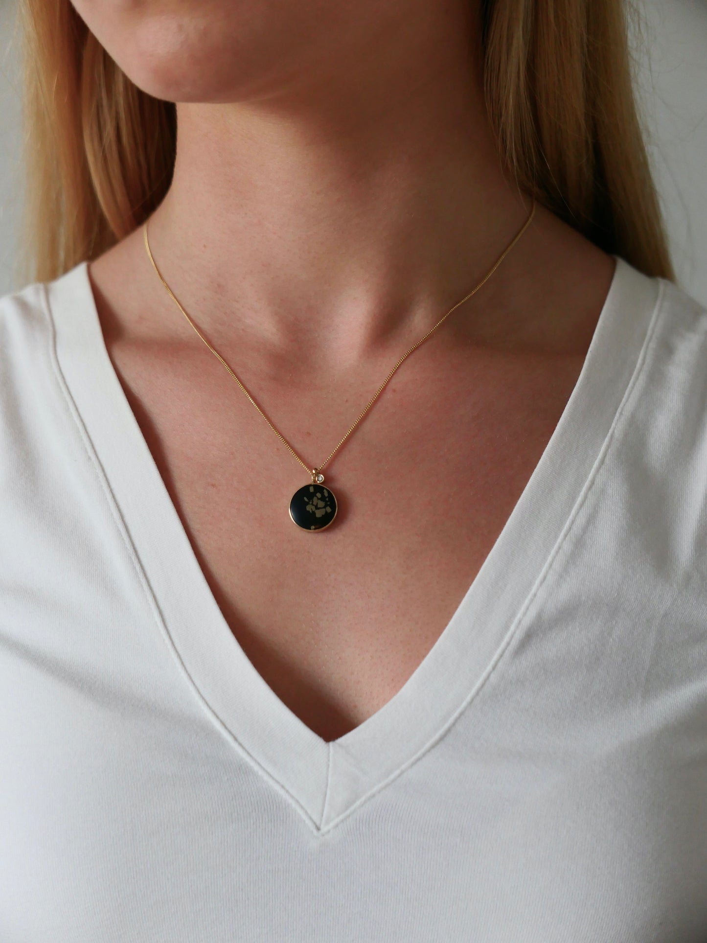 black and gold slate pyrite pendant gold necklace with diamond on model