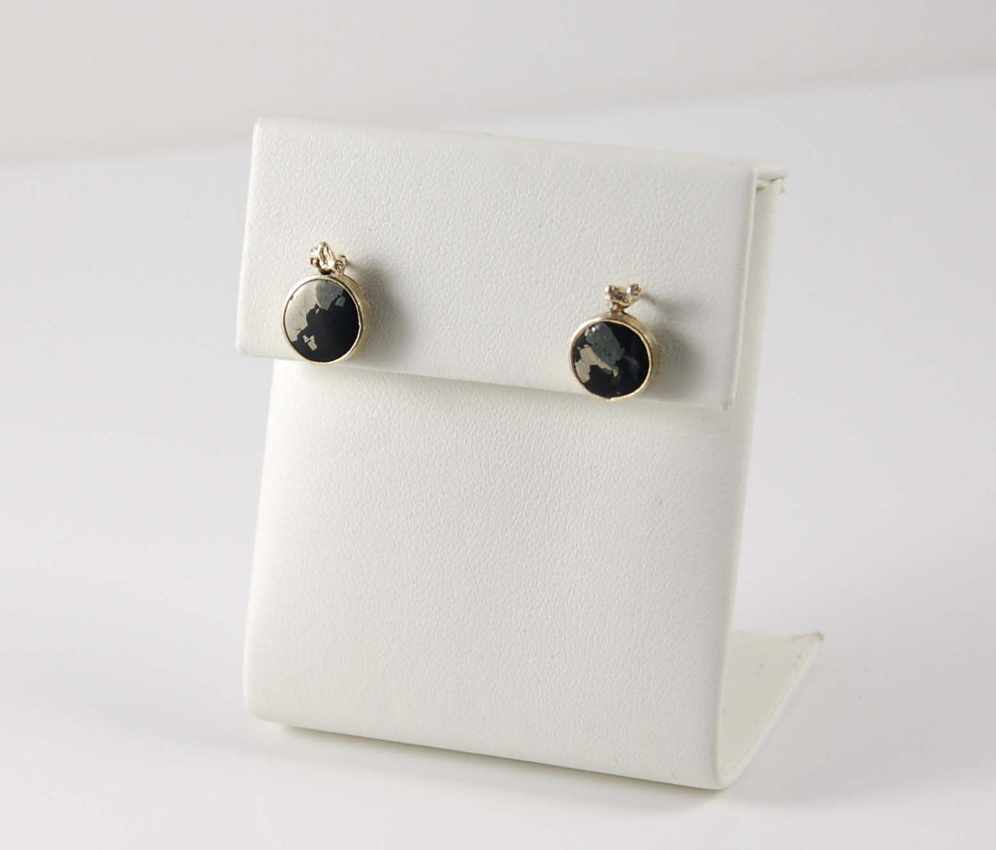 black and gold earring studs on display