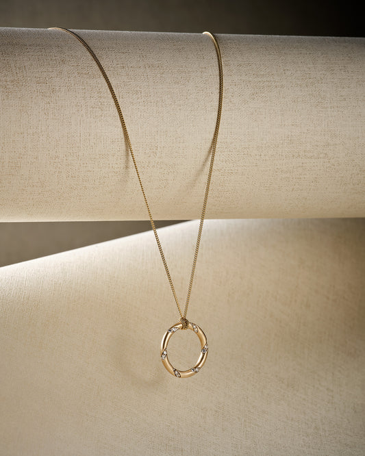 yellow gold hoop pendant necklace with diamonds hanging with shadow