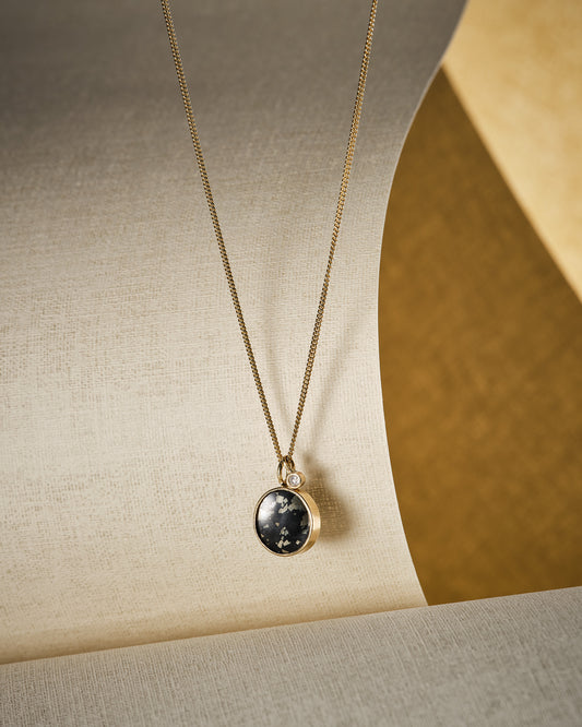 small black and gold necklace with diamond