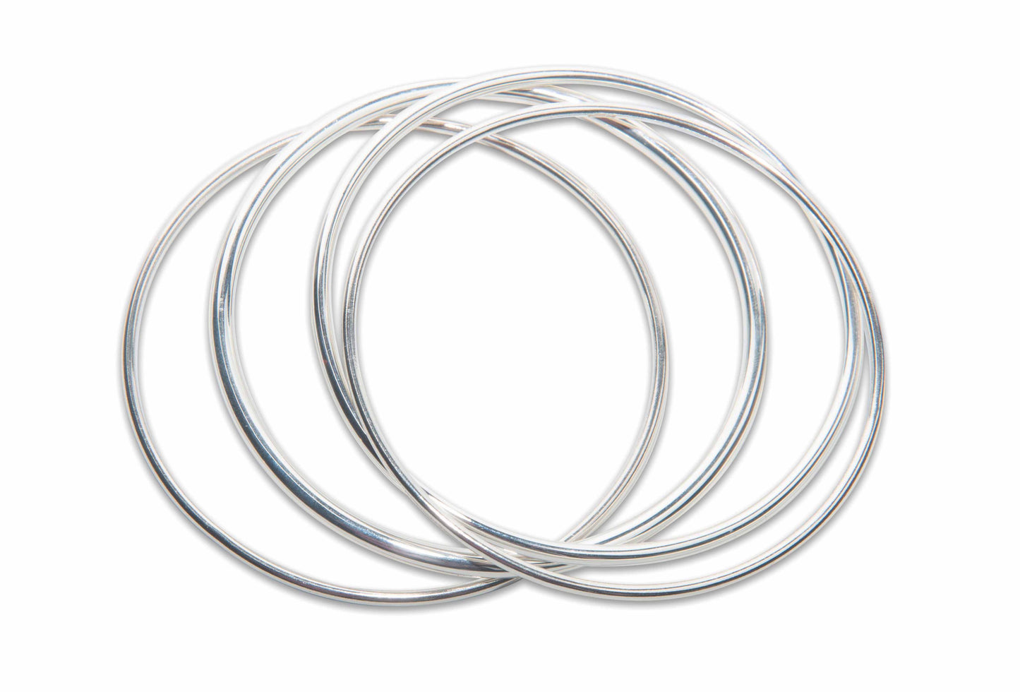 recycled silver bangles on white background